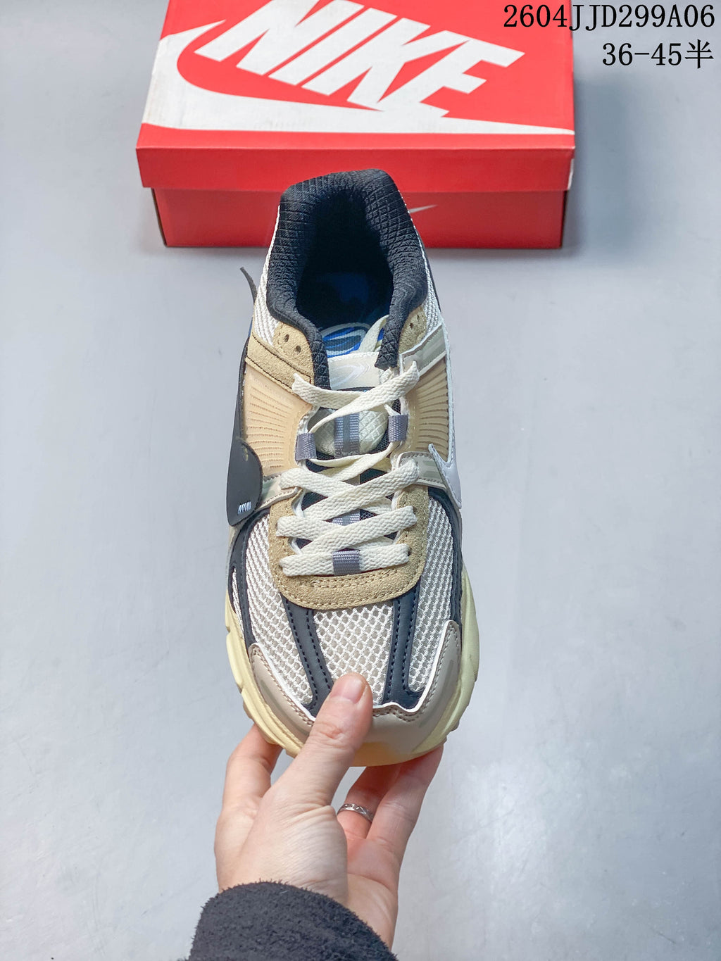 Top view of a Nike Zoom Vomero 5 sneaker with cream laces and layered upper panels.