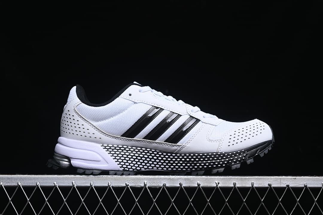 Side profile of the white sneaker with black stripes