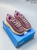 Pair of plum HOKA Tor Summit sneakers on a blue shoe box, shown from above.