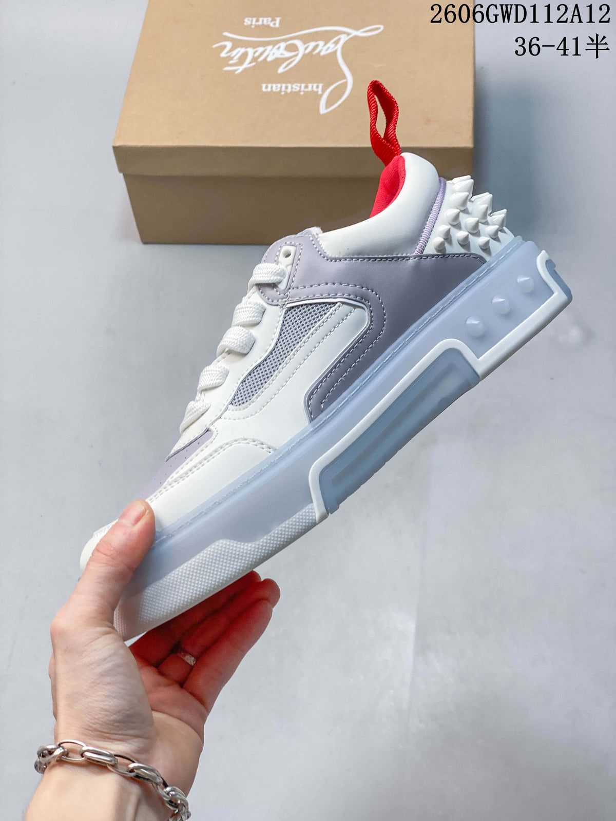 Side profile of a white and grey sneaker with studded heel detailing