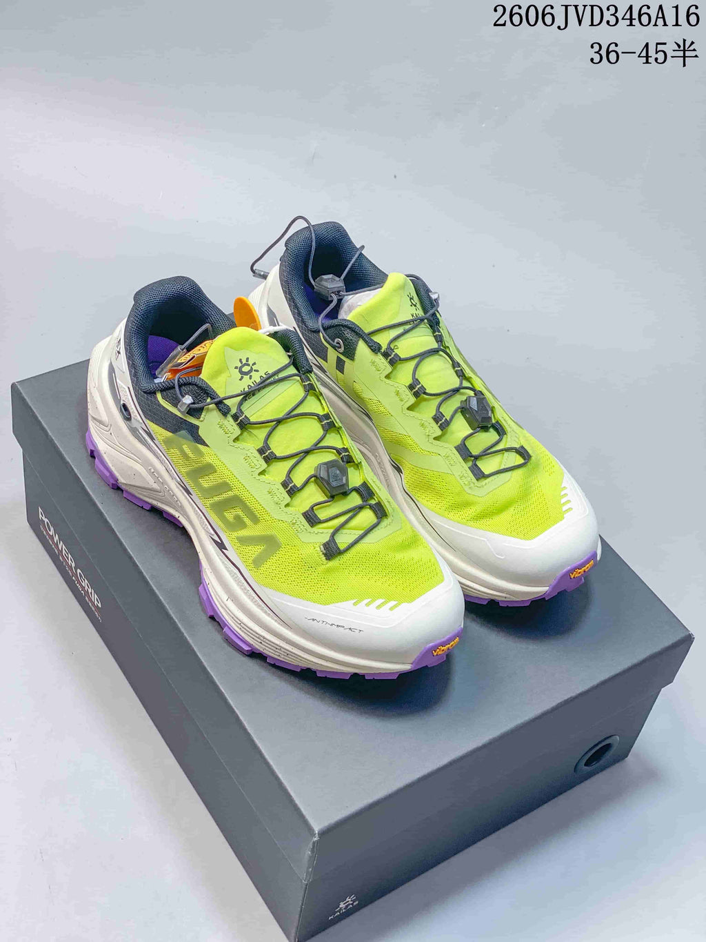 Pair of neon yellow, white, navy, and purple Kailas FUGA EX3 trail running shoes on a shoebox
