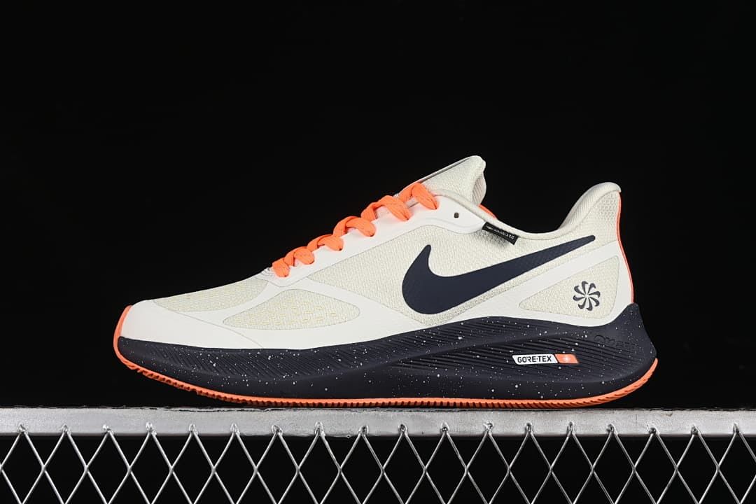 Side profile of the shoe with navy swoosh, orange laces, and dark speckled midsole
