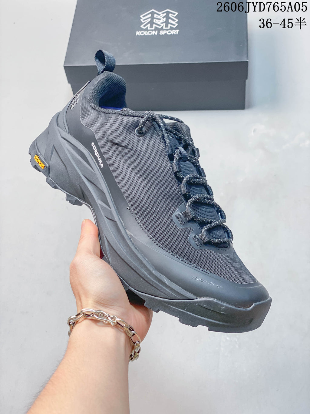Angled side view of the dark gray hiking shoe with lace-up closure
