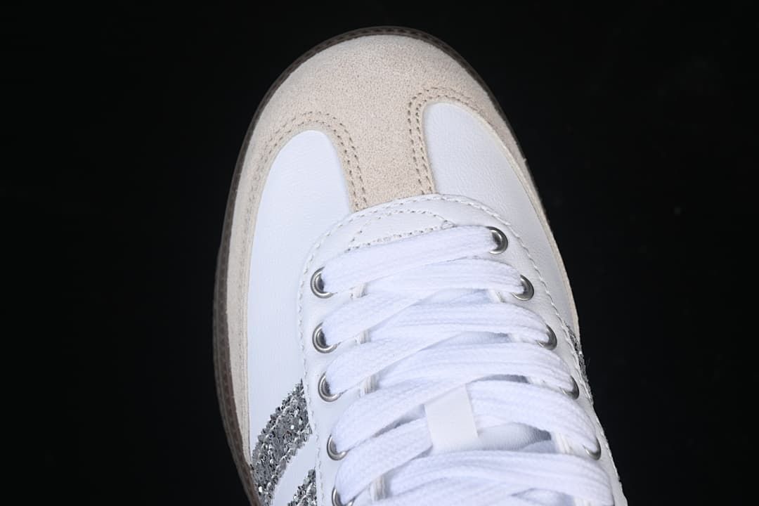 Top-down close-up of the beige toe overlay and white lace-up front.