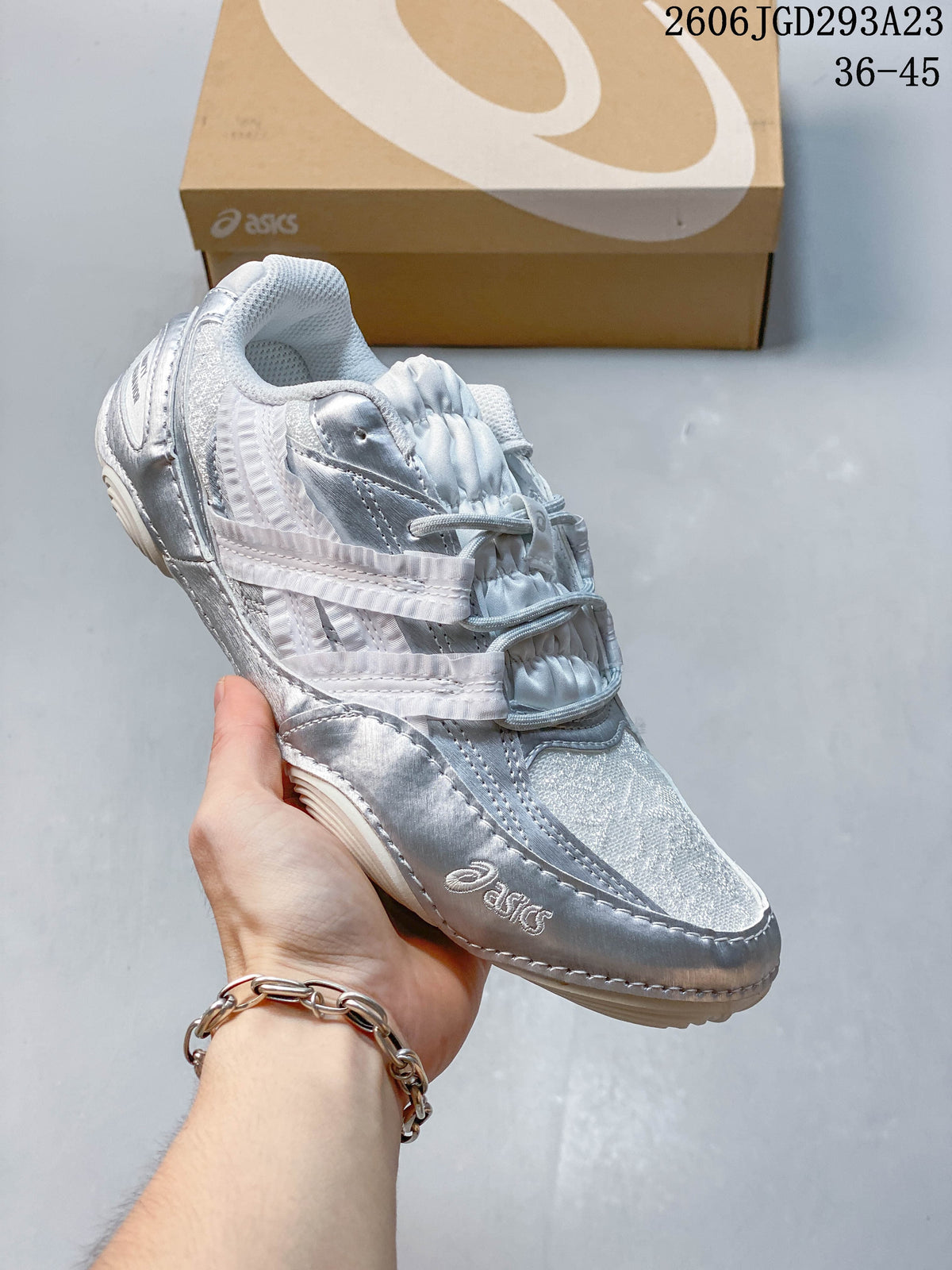 Silver and white ASICS Gel-Pickax sneaker with a light mesh upper.