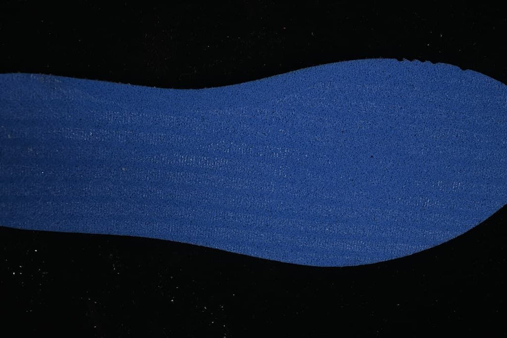 Blue textured shoe insert displayed against a dark background