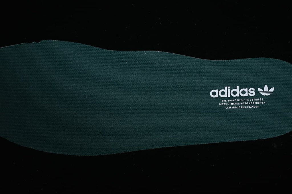 Close-up of the dark green insole with Adidas branding