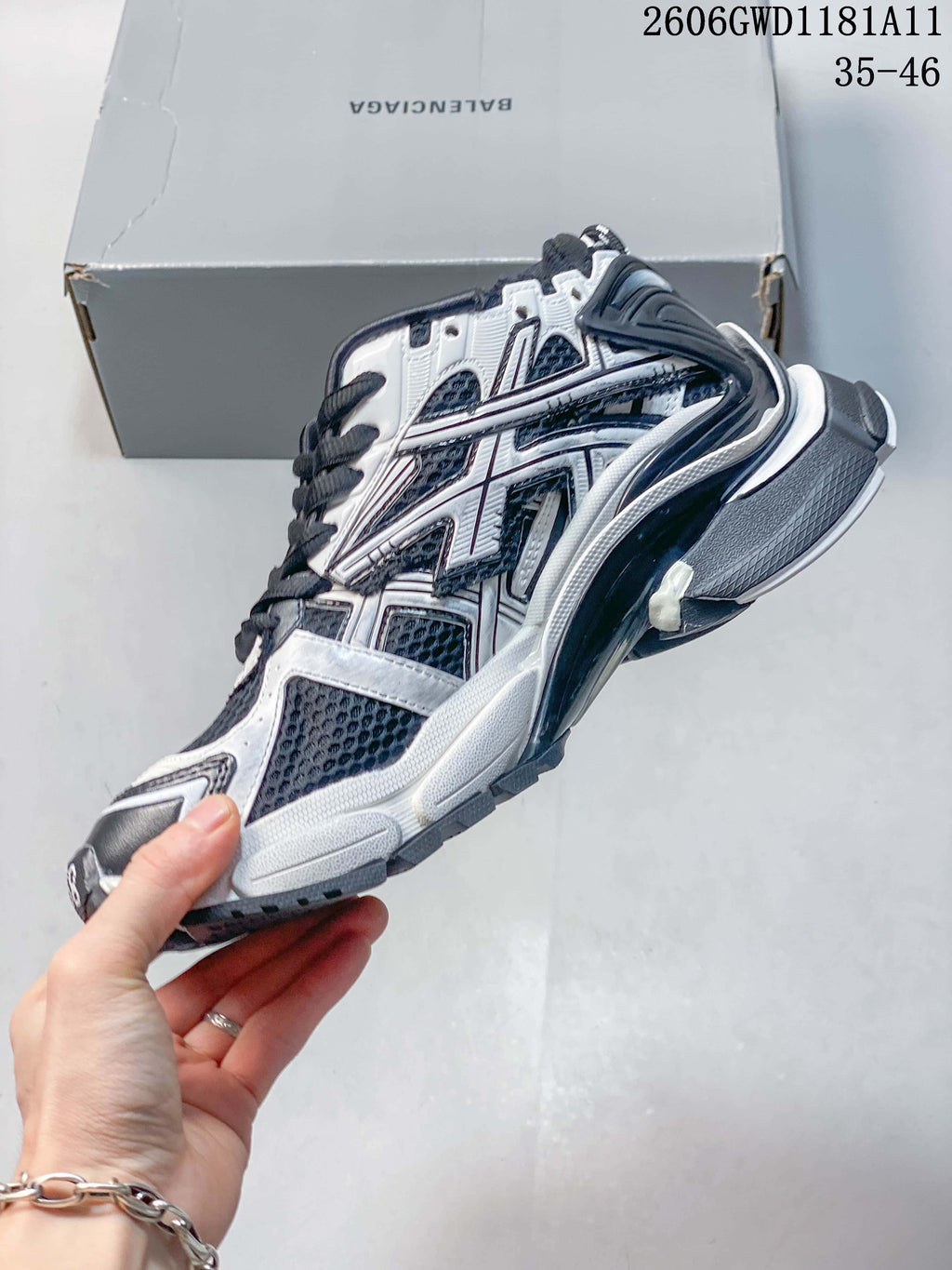 Side view of a white and navy Balenciaga Runner Gradient sneaker with mesh panels