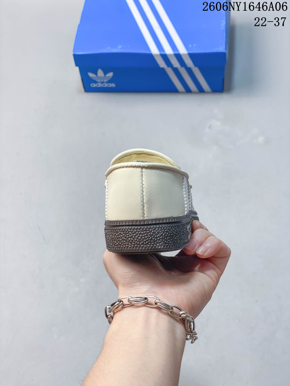 Rear view of the cream shoe with a dark textured sole