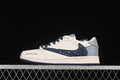 Side view of a cream low-top sneaker with a speckled navy swoosh and gray heel panel.