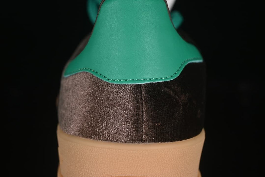Close-up of the teal heel tab and dark brown heel panel.