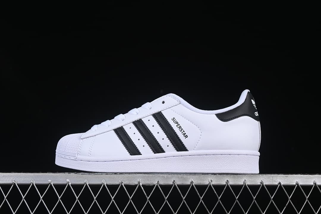 Side view of white adidas Superstar II sneakers with black stripes and a shell toe