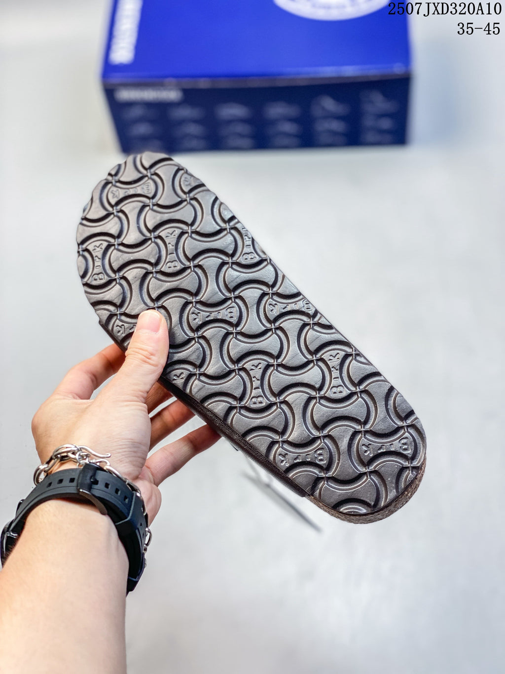 Close-up of the textured outsole on a dark brown slide sandal.