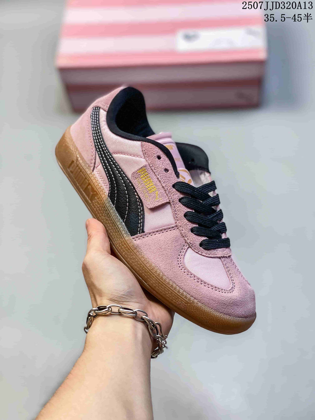 Angled side view of a pink Puma Palermo sneaker with black side stripe and gum sole