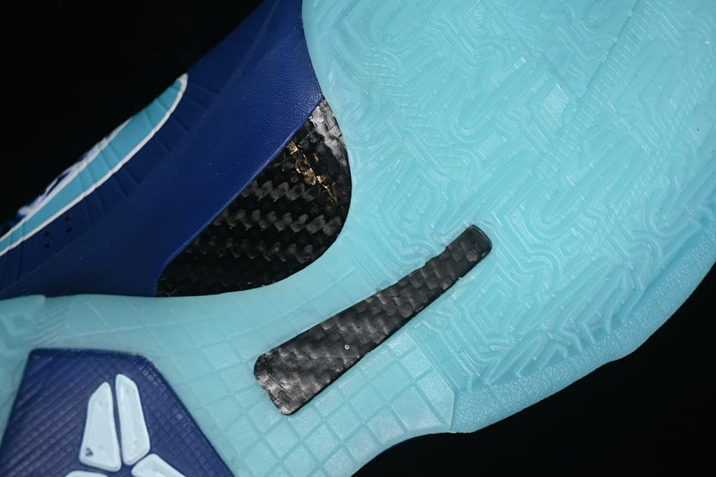 Close-up of aqua outsole and dark patterned midfoot component