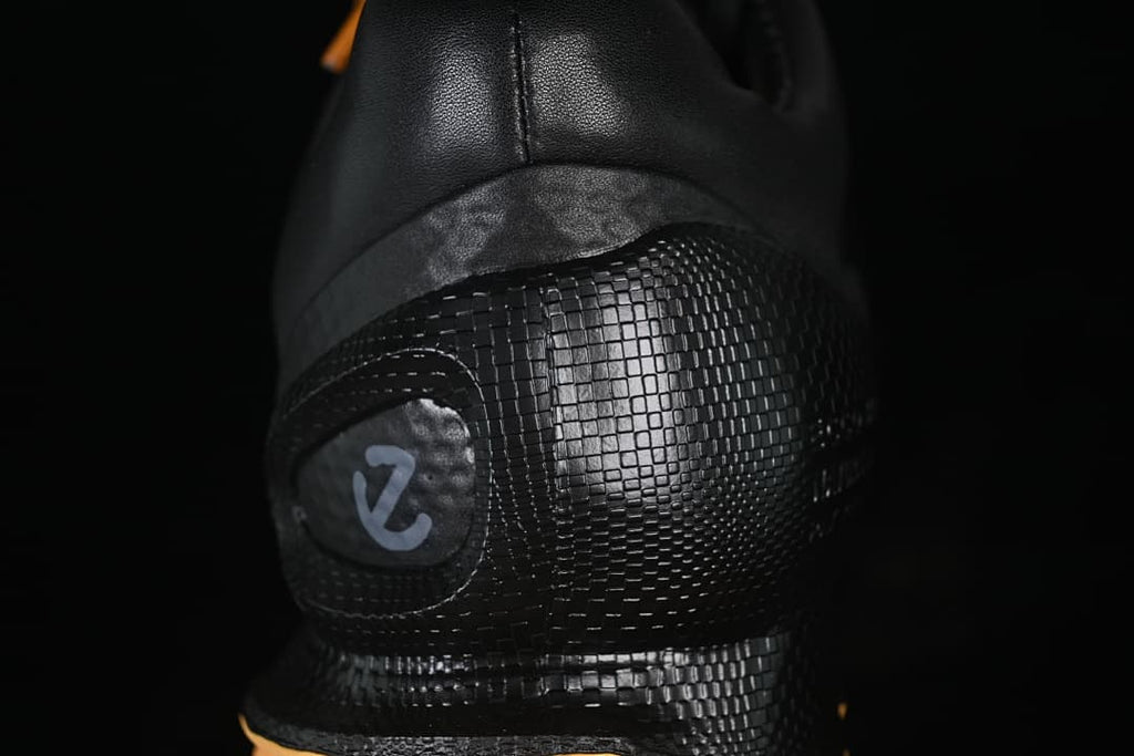 Close-up of the textured black heel panel and logo detail
