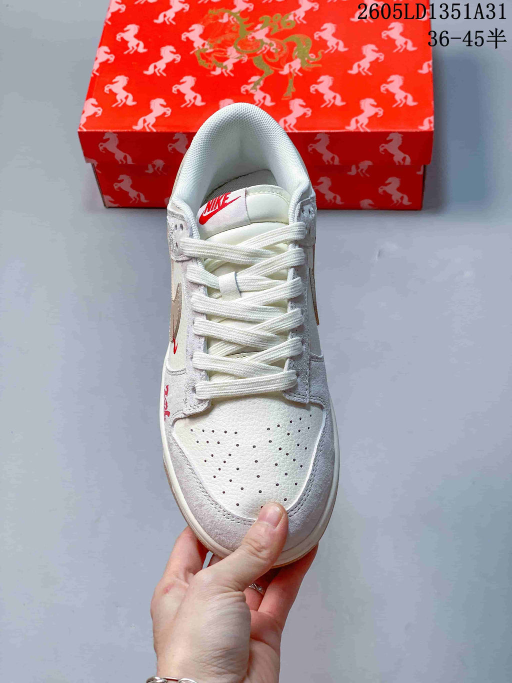 Top view showing the perforated toe, white laces, and red tongue logo
