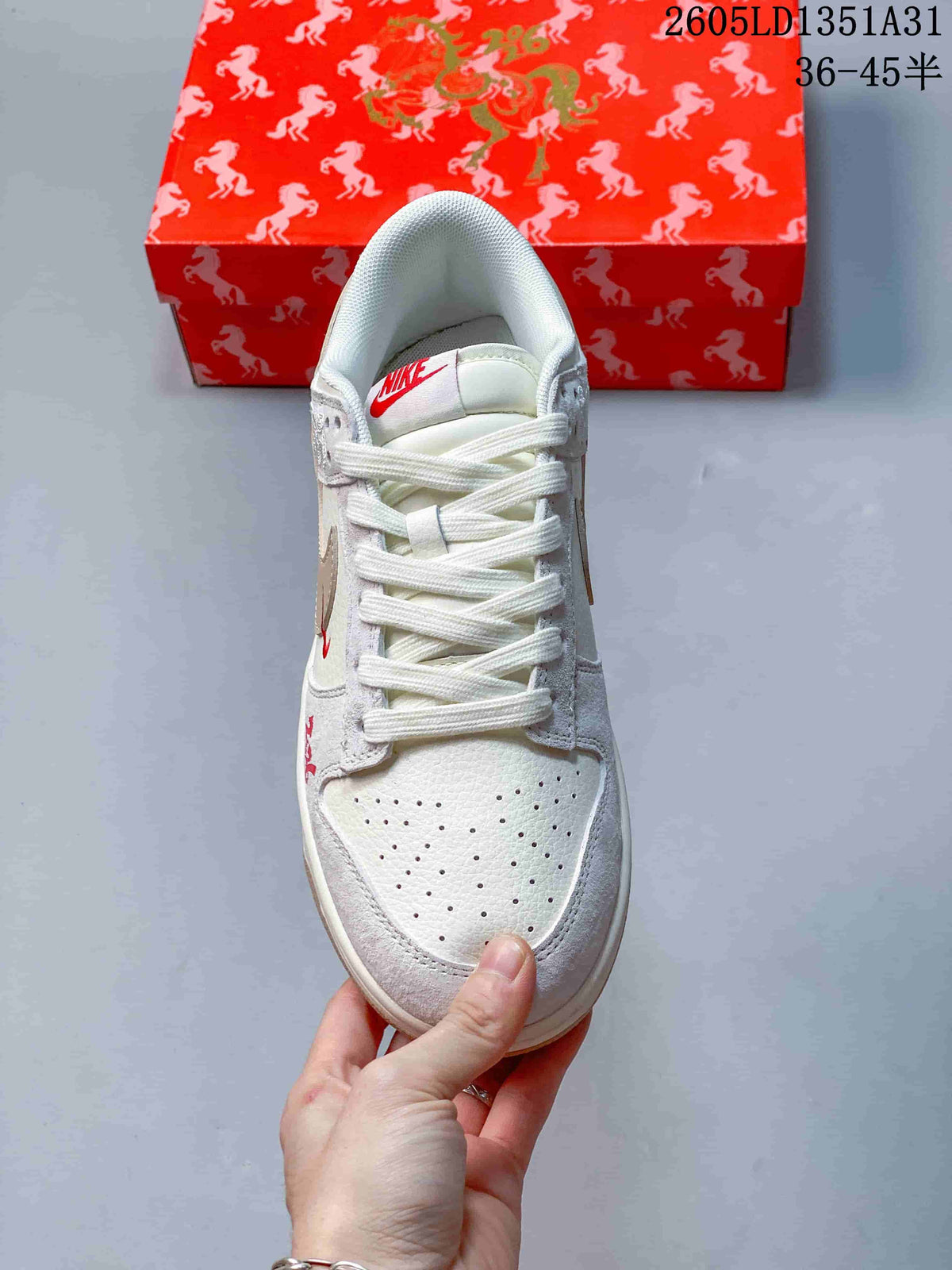 Top view showing the perforated toe, white laces, and red tongue logo