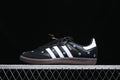 Side view of black adidas Samba OG sneakers with white stripes, blue floral details, and dark outsole