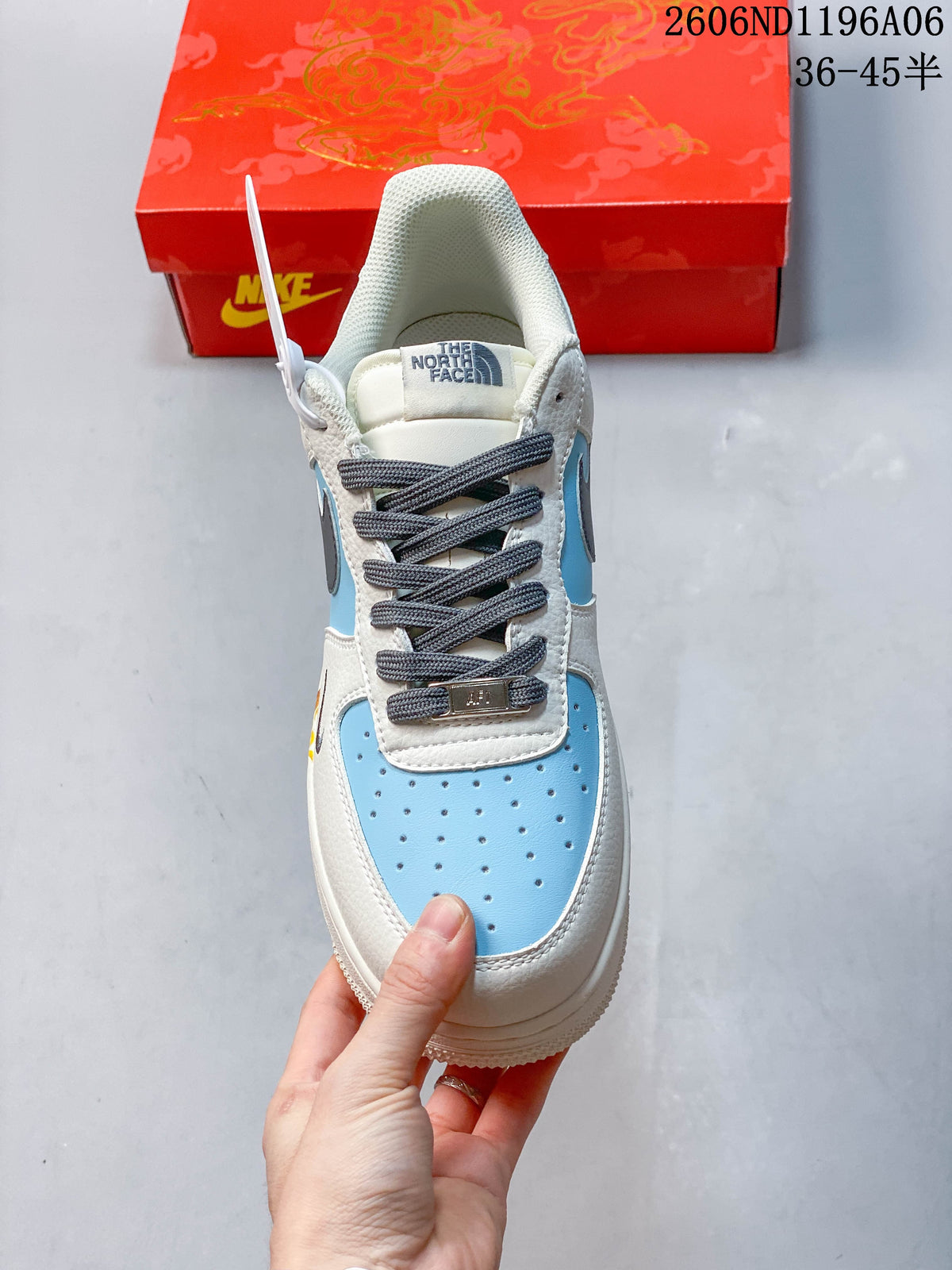 Front view showing perforated light blue toe panel and gray laces.