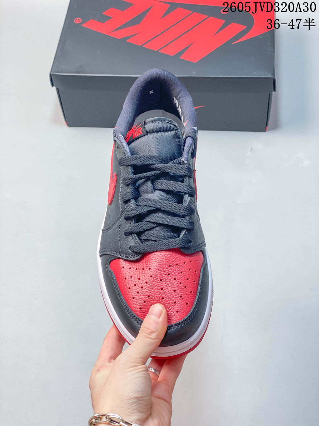 Front view showing the perforated red toe and dark grey laces