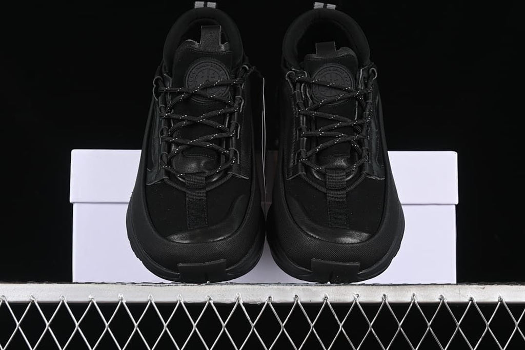 Front view of the pair of black trail sneakers