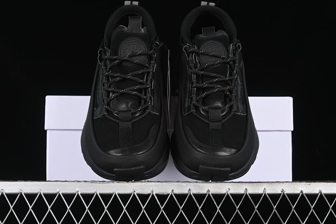 Front view of the pair of black trail sneakers