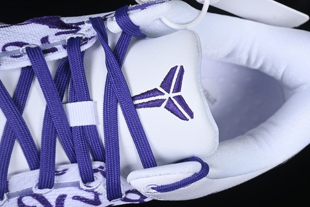 Close-up of tongue logo and purple lacing