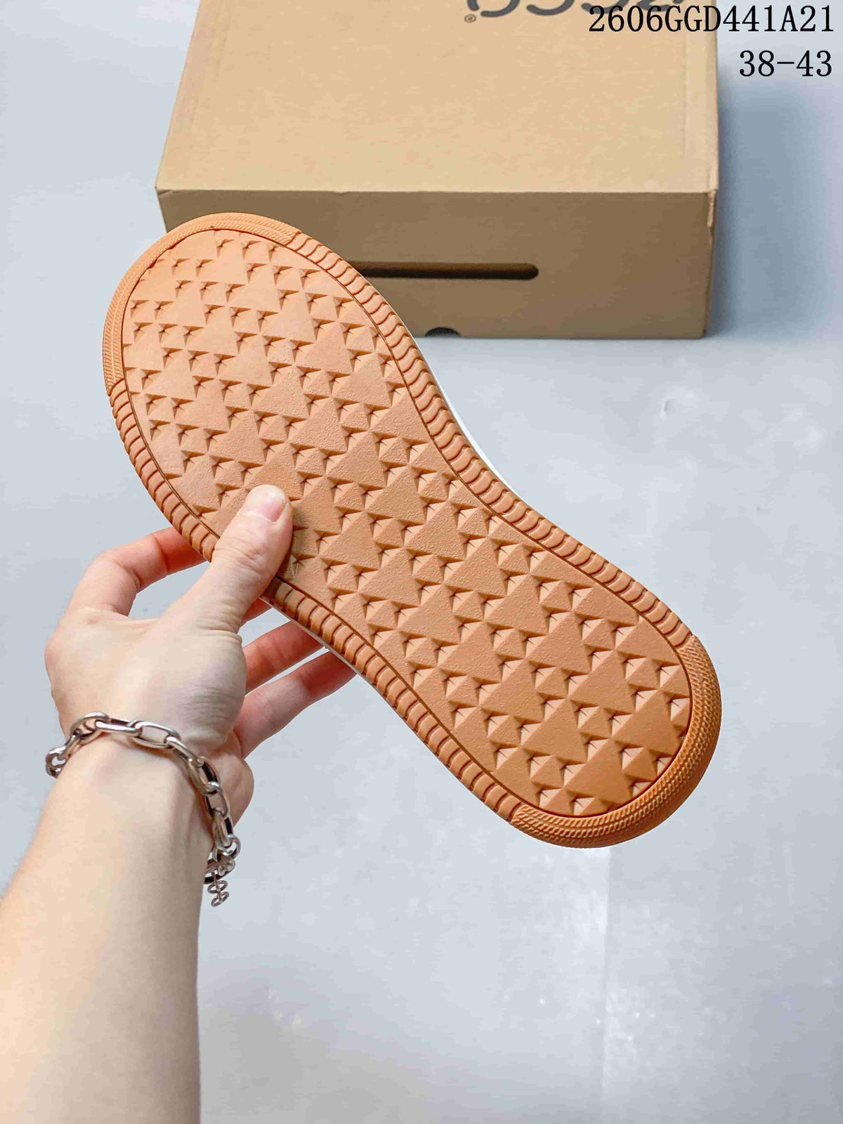 Close-up of the gum-colored sneaker outsole with geometric tread.