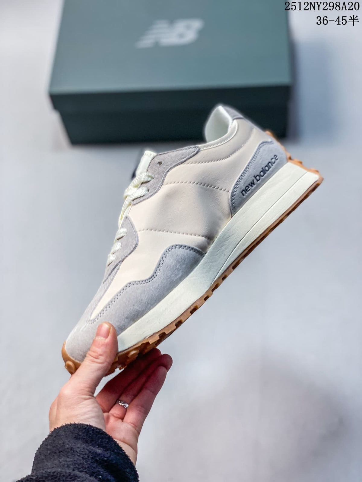 Side profile showing cream and gray panels, navy branding and an off-white midsole.