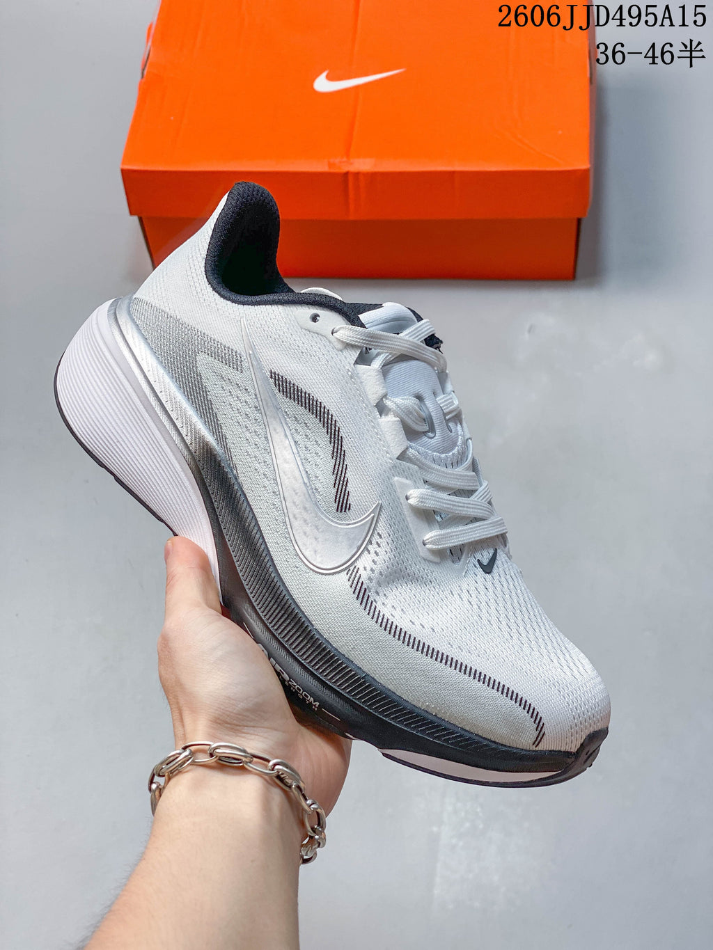 Light gray Nike Air Zoom Pegasus 42 shoe with dark side details