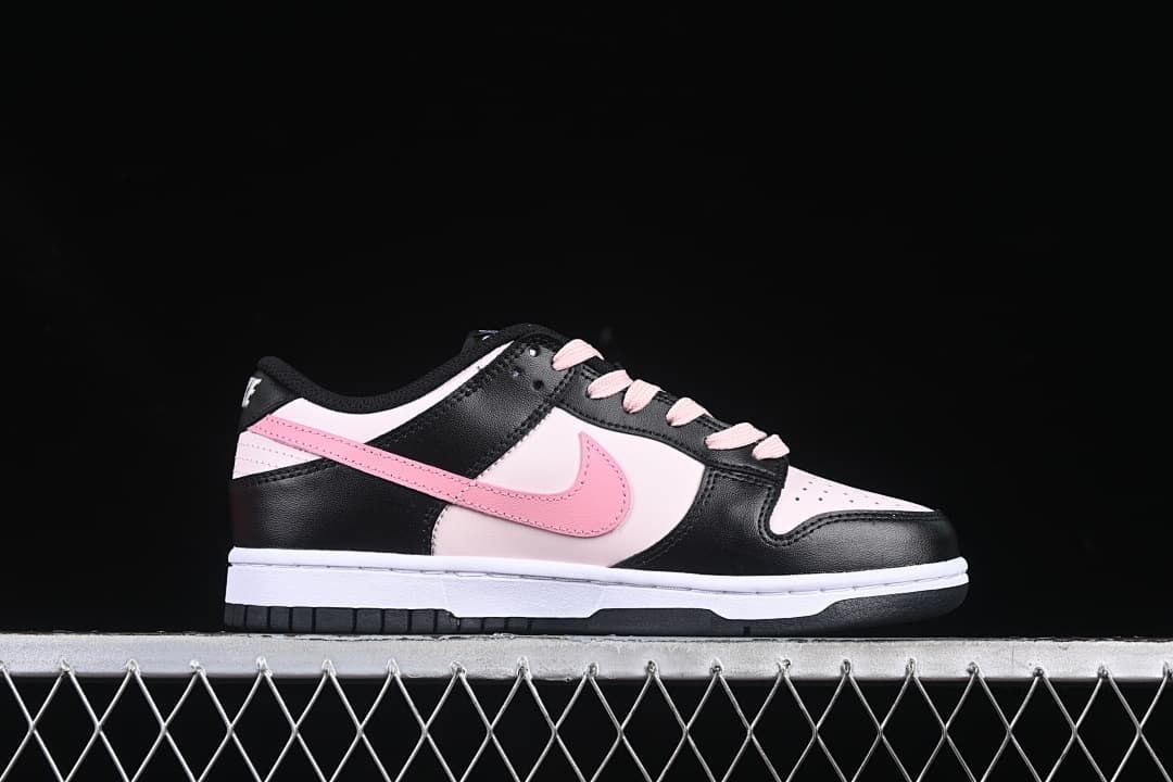 Side profile of a low-top sneaker in black, pale pink, and white