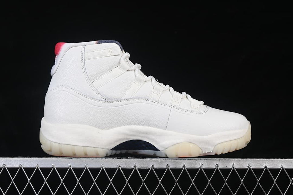 Side profile of a white Air Jordan 11 Retro high-top sneaker.