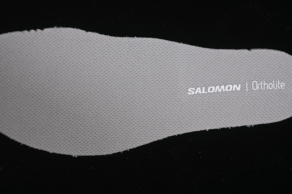 Close-up of a gray insole with Salomon and Ortholite branding.
