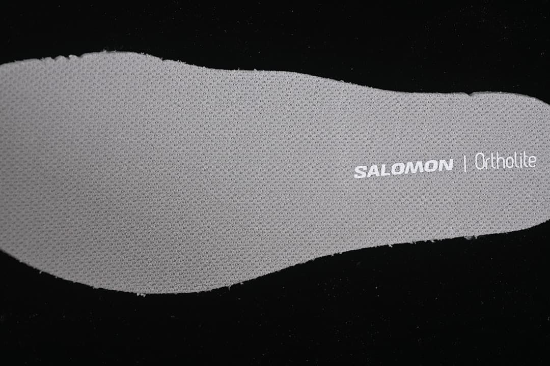 Close-up of a gray insole with Salomon and Ortholite branding.