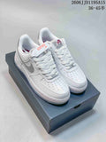 White low-top sneakers with silver reflective-look Swoosh accents, shown on a shoe box.
