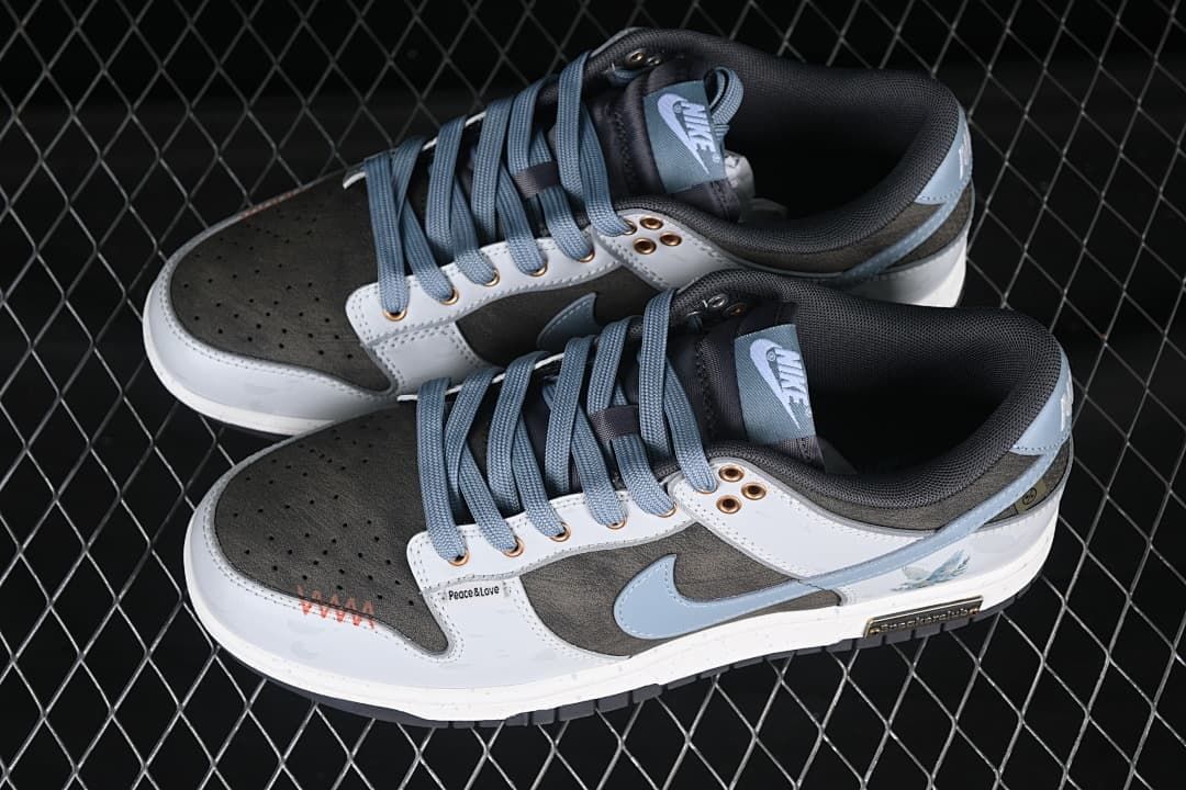 Pair of gray, white, and pale blue Nike SB Dunk Low sneakers photographed from above
