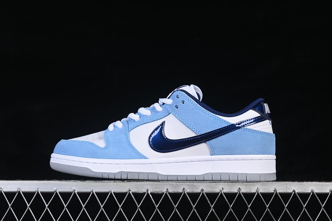 Side view of a white and light-blue low-top sneaker with a navy Swoosh and light-colored outsole.