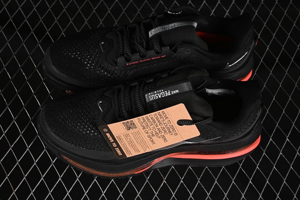 Pair of black Pegasus Premium shoes with coral accents and hangtag