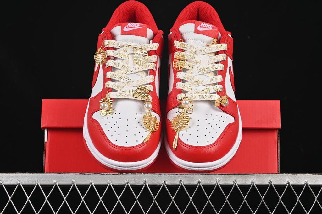 Front view of both sneakers with decorative laces and gold-tone charms
