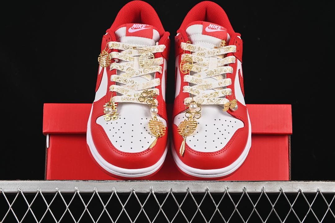 Front view of both sneakers with decorative laces and gold-tone charms