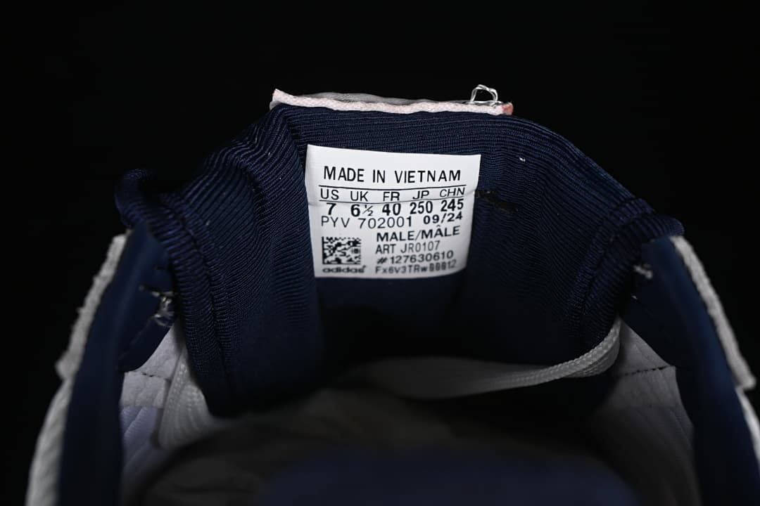 Sneaker tongue label showing size conversions and model code JR0107