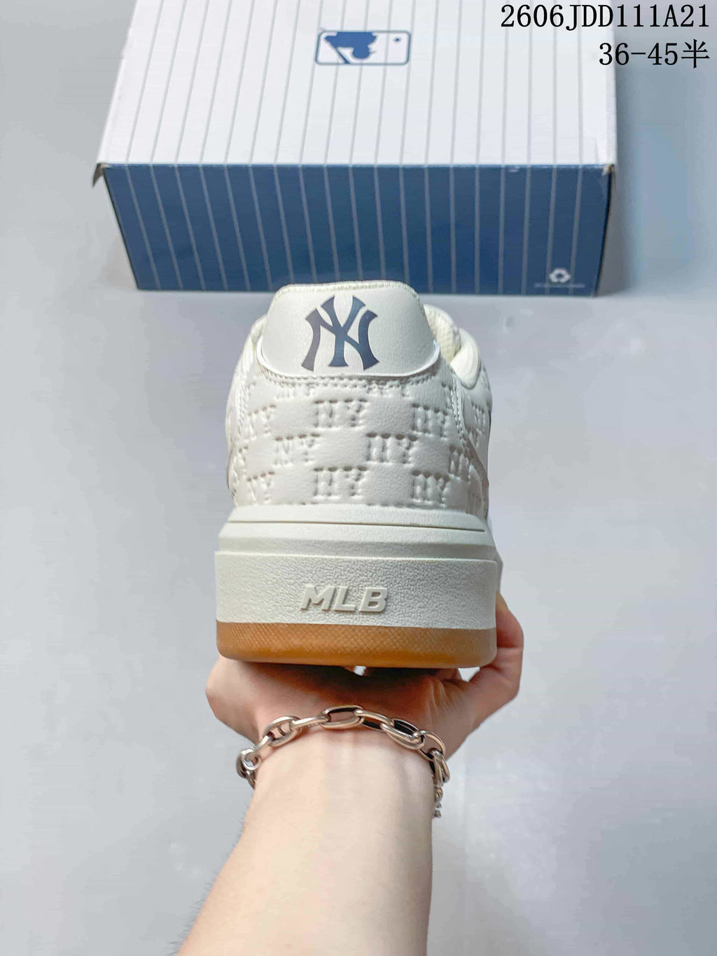 Rear view showing the ivory heel, raised midsole, and branding