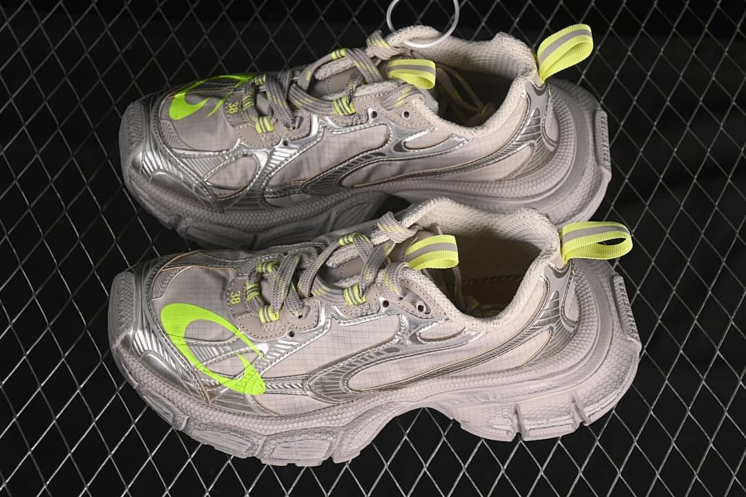 Pair of taupe and fluorescent yellow 3XL sneakers in side view
