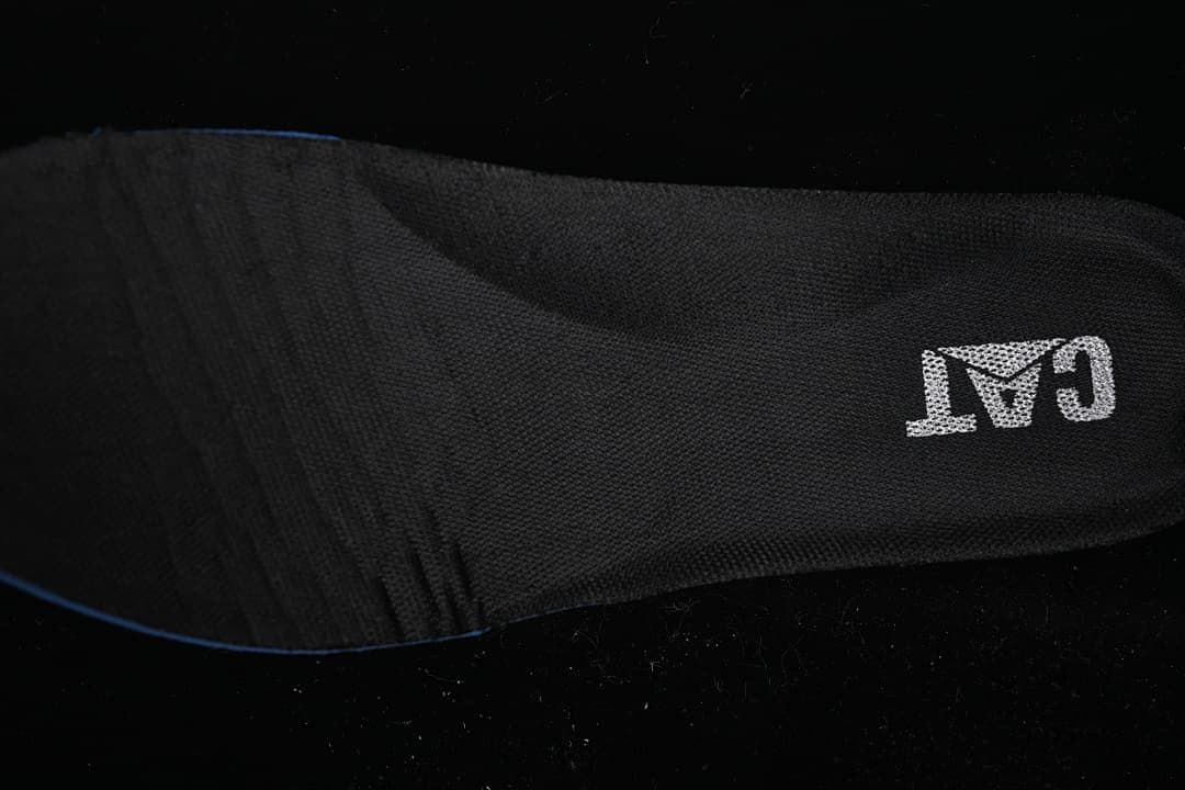Close-up of a black insole bearing CAT branding