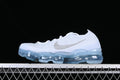 White Nike Air VaporMax 2023 Flyknit sneaker with metallic-look Swoosh and translucent blue sole, side view