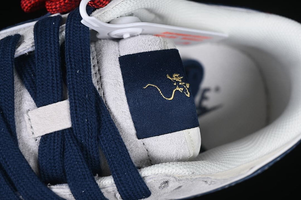 Close-up of navy laces and tongue with gold-tone decorative stitching