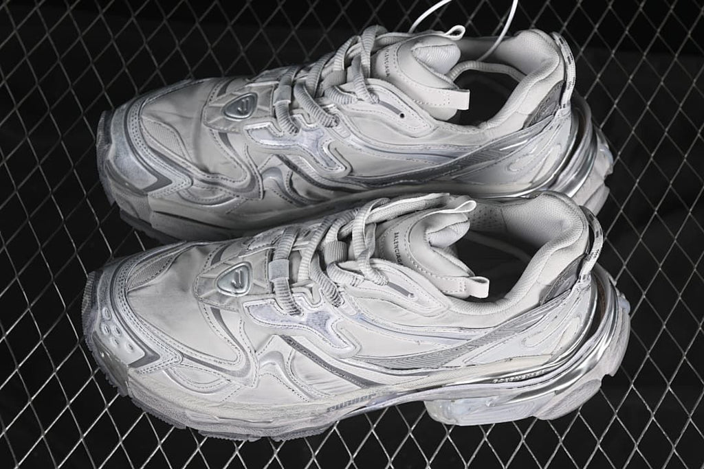 Pair of grey and silver sneakers shown from above.