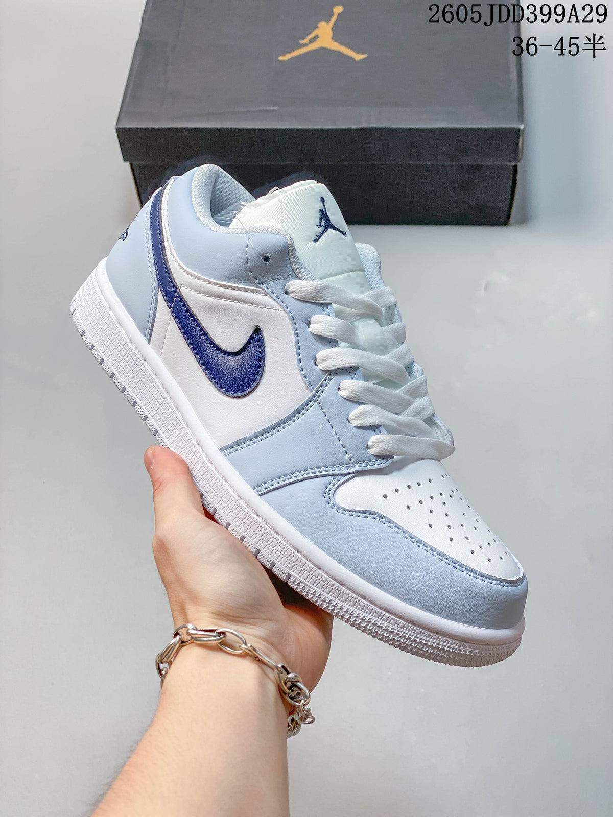 Angled side view of a white and light blue low-top sneaker