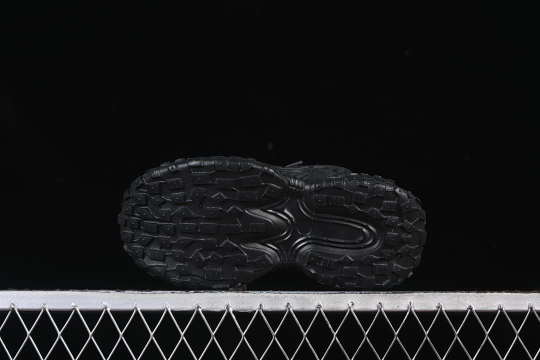 Underside view showing the patterned black outsoles.